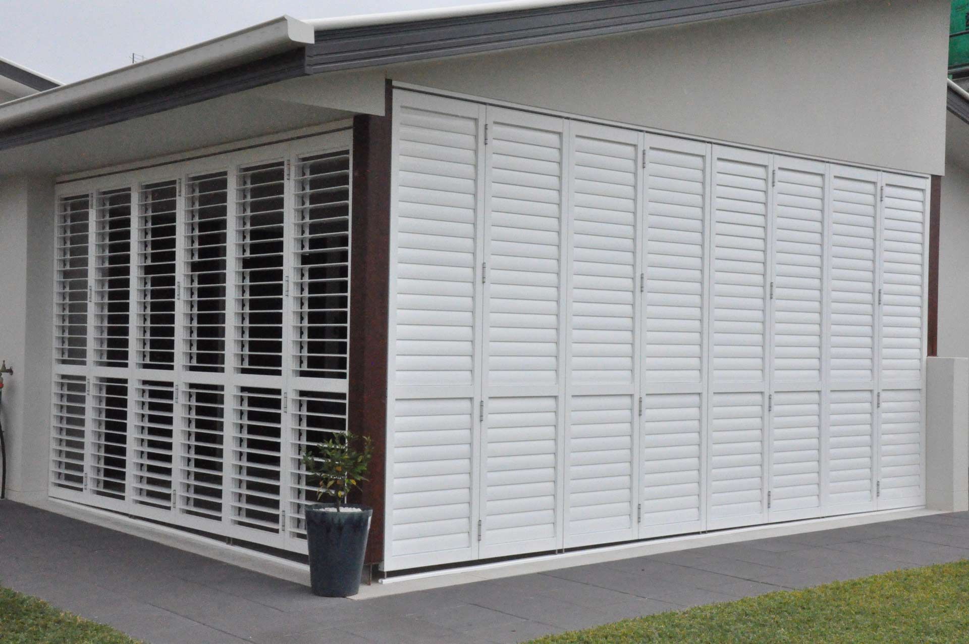 A House With White Shutters On The Side Of It — Balcony Shutters Australia In Moffat Beach, QLD