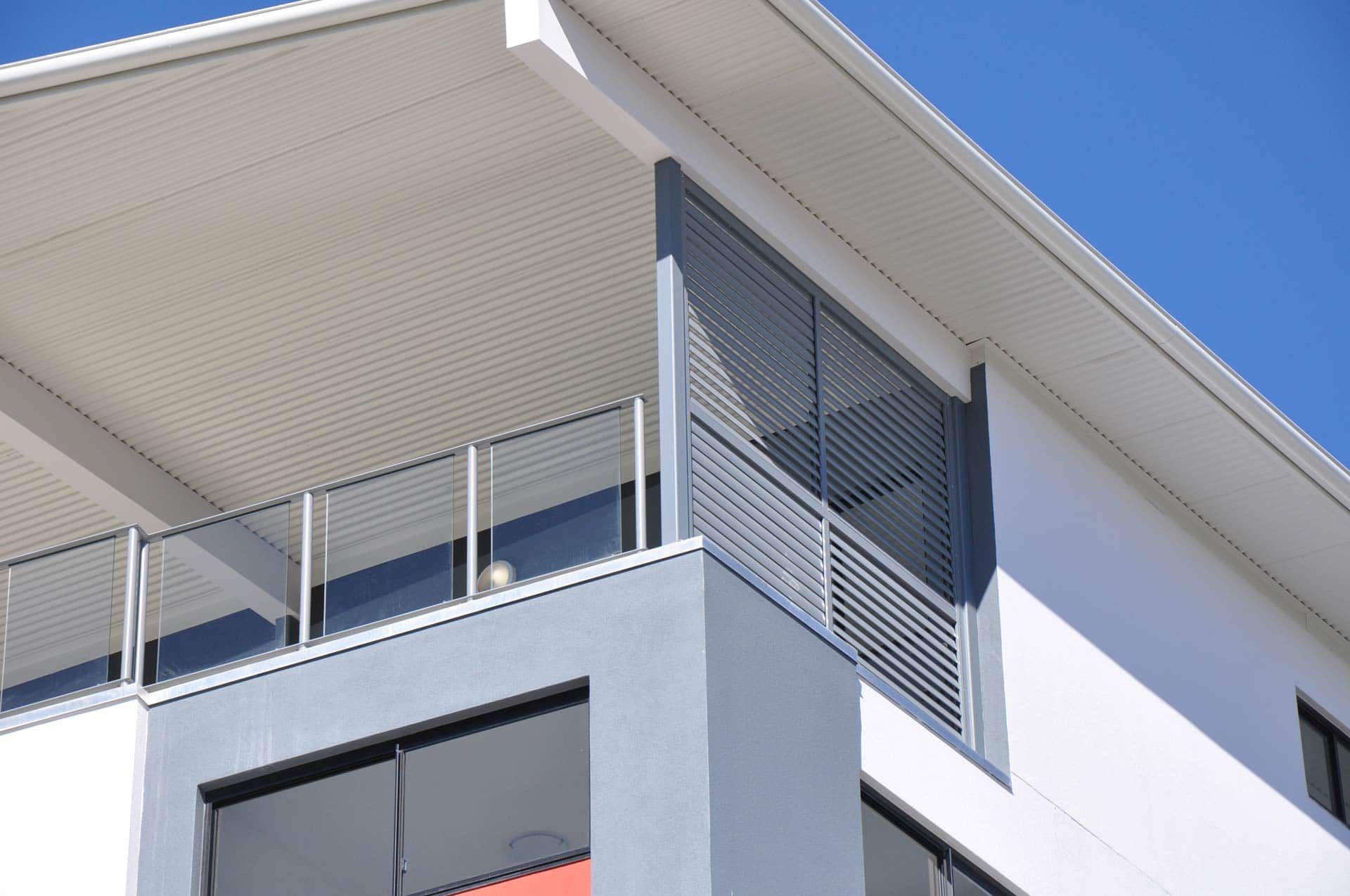 A Building With A Balcony And A Blue Sky In The Background — Balcony Shutters Australia In Moffat Beach, QLD