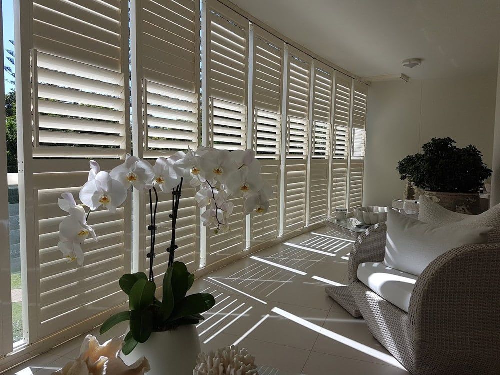 A Living Room With White Shutters — Balcony Shutters Australia In Moffat Beach, QLD