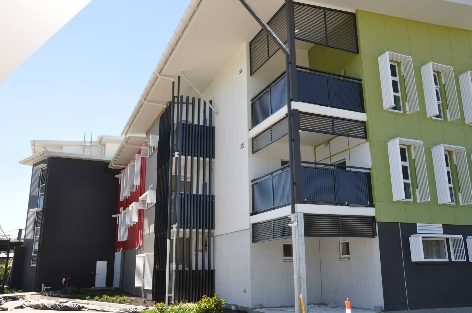 Three Story Building with Balcony Shutters