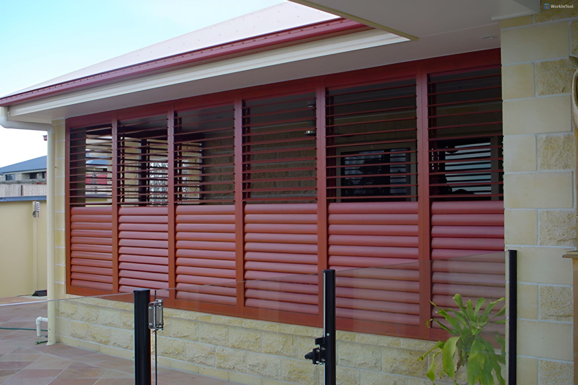 A Building With A Lot Of Windows And Shutters On It — Balcony Shutters Australia In Moffat Beach, QLD