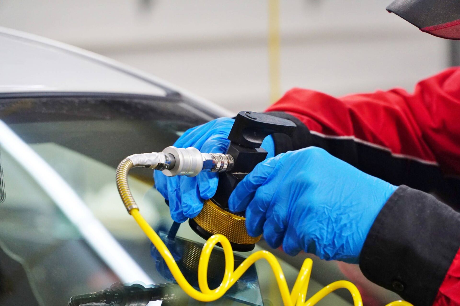 Man's Hands In Blue Gloves Repairing Windscreen – Coffs Harbour, NSW – City Autoglass Pty Ltd