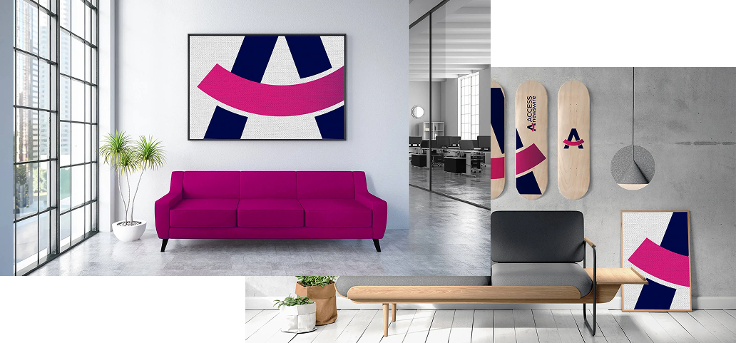 A living room with a pink couch and a painting on the wall.