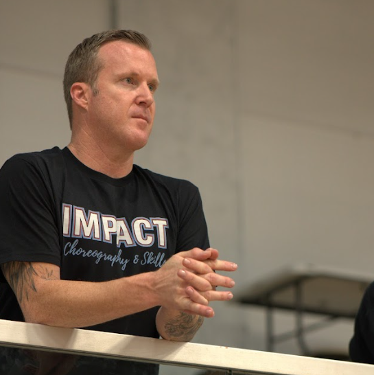 Photo of choreographer Josh McCurdy leading a choreography session with athletes.