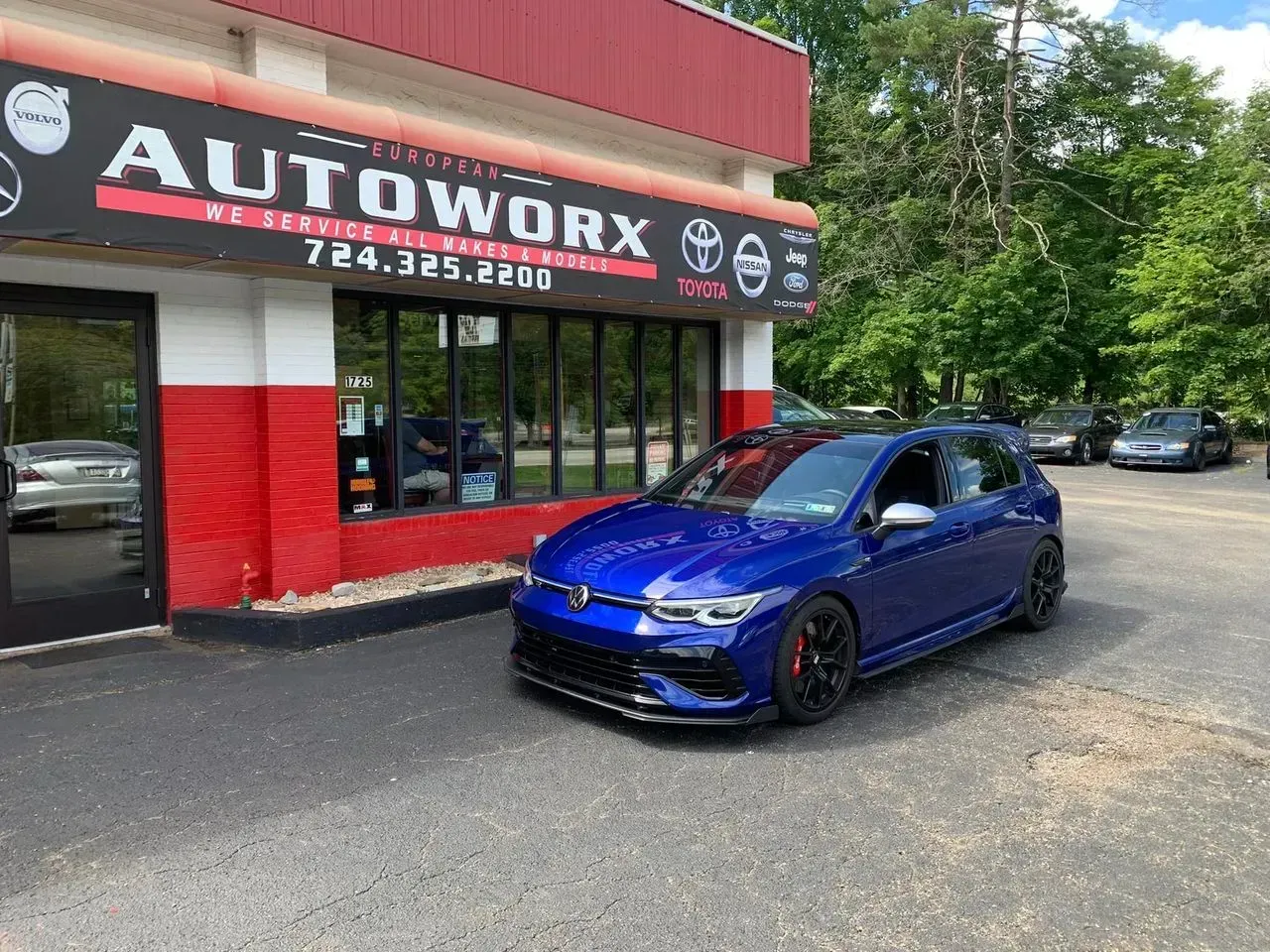 Blue Volkswagen Car Parked in Front of a Car Repair Shop | European Autoworx