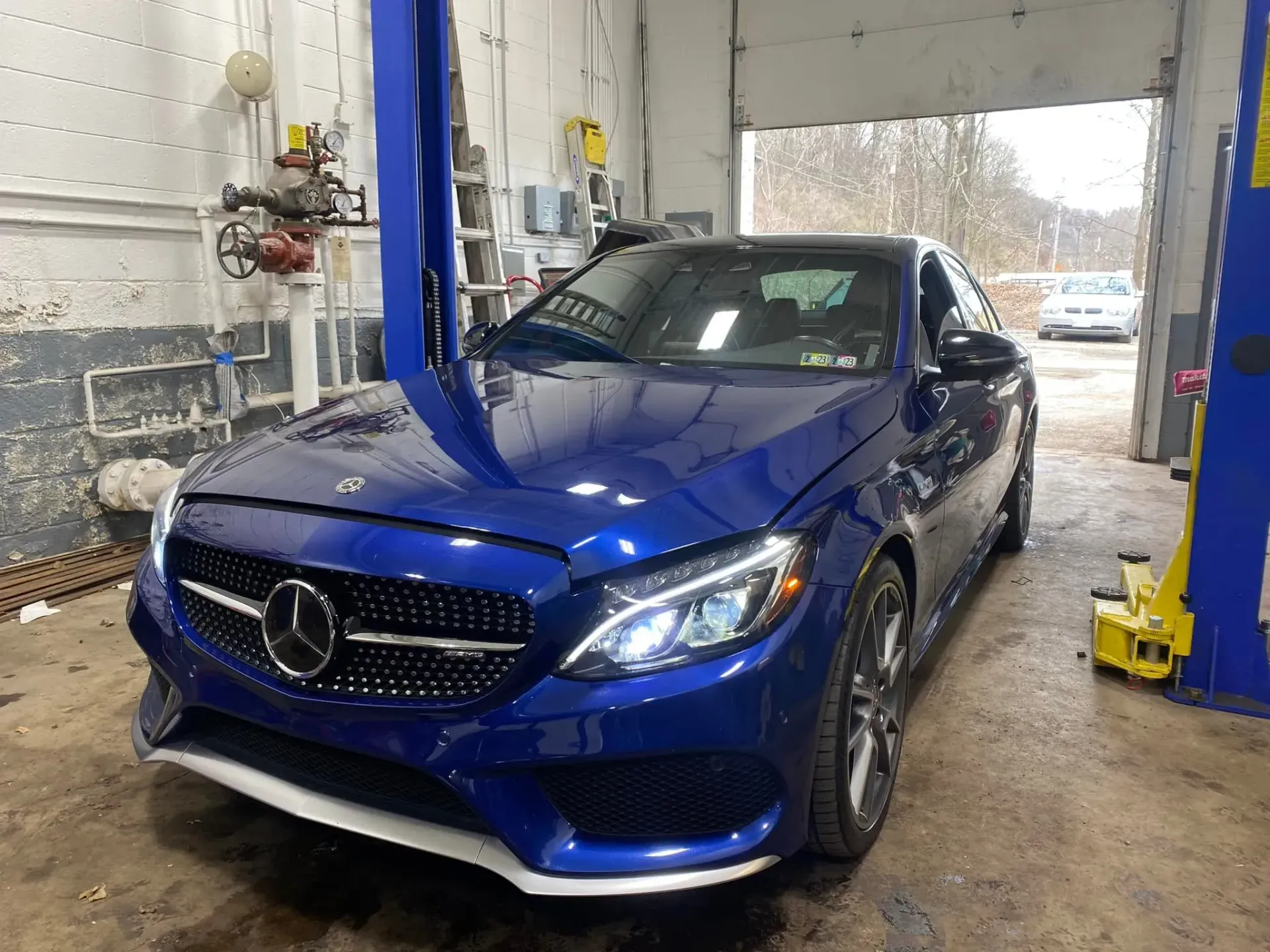 Blue Mercedes-Benz Coupe in a Garage, Under a lift | European Autoworx