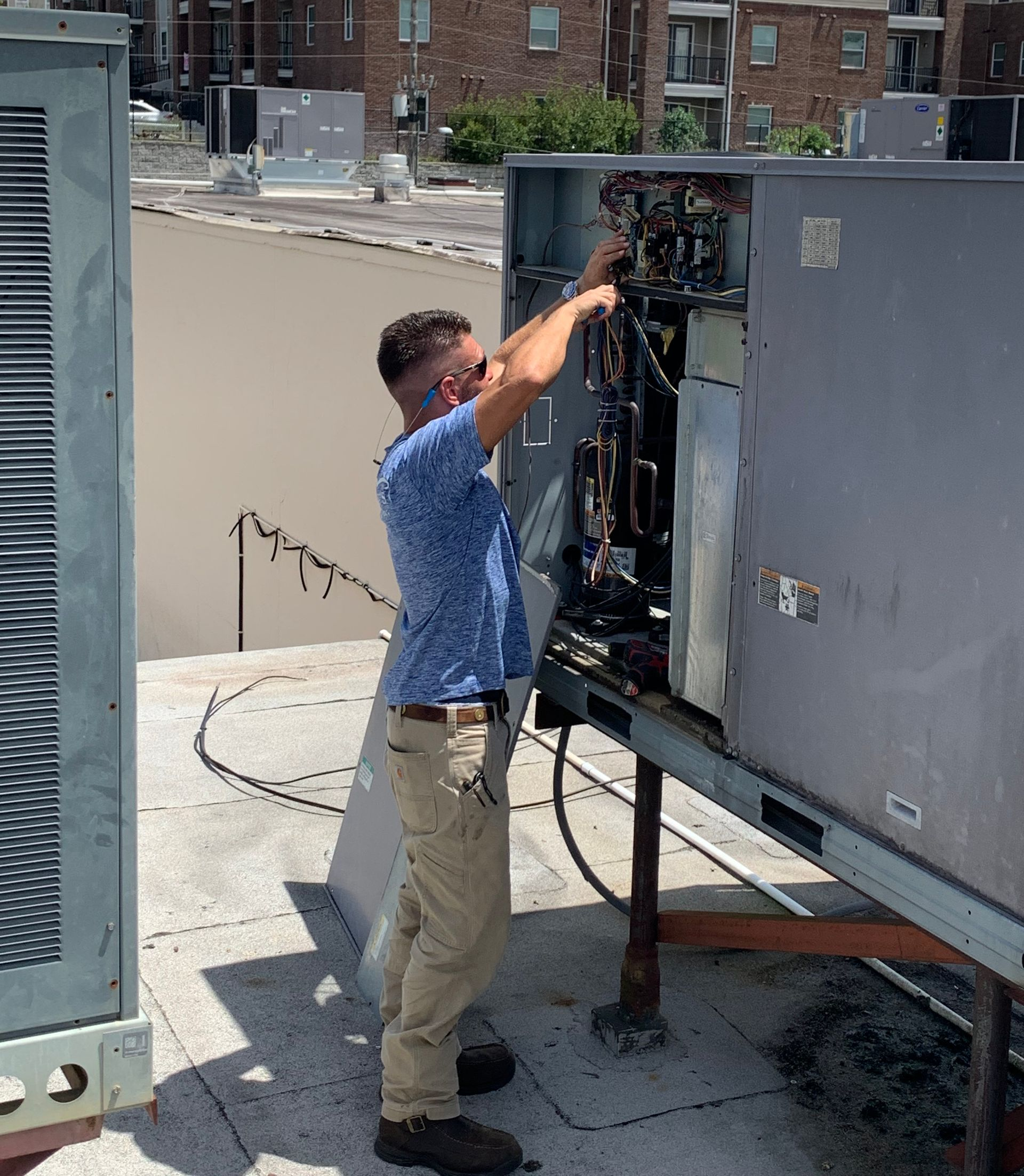 Workers install air conditioning - Tallahassee, FL - Todd King's Heating and Cooling Workers install air conditioning - Tallahassee, FL - Todd King's Heating and Cooling