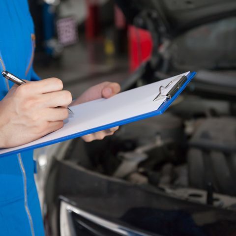 Young mechanic engineer taking a note — Logbook Servicing in Port Macquarie, NSW