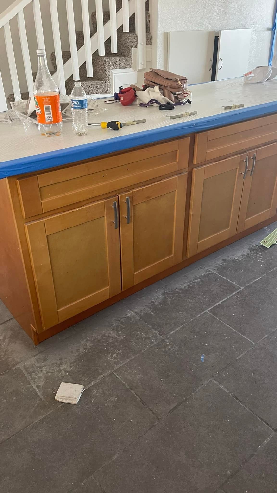 Wooden kitchen cabinets with a light countertop, construction in progress.