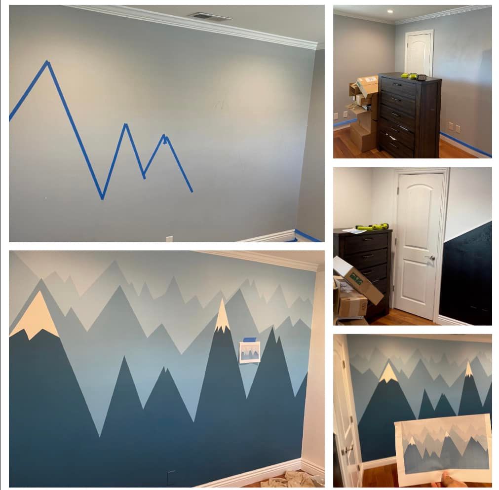 A room with a painted mountain mural in shades of blue and beige.
