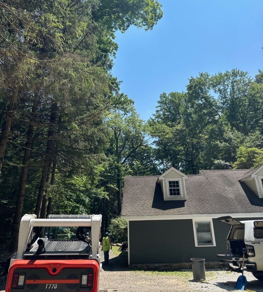 A house with a forklift parked in front of it