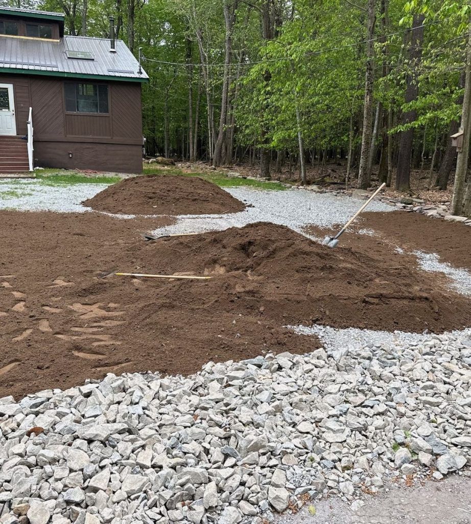 A pile of dirt and rocks in front of a house.