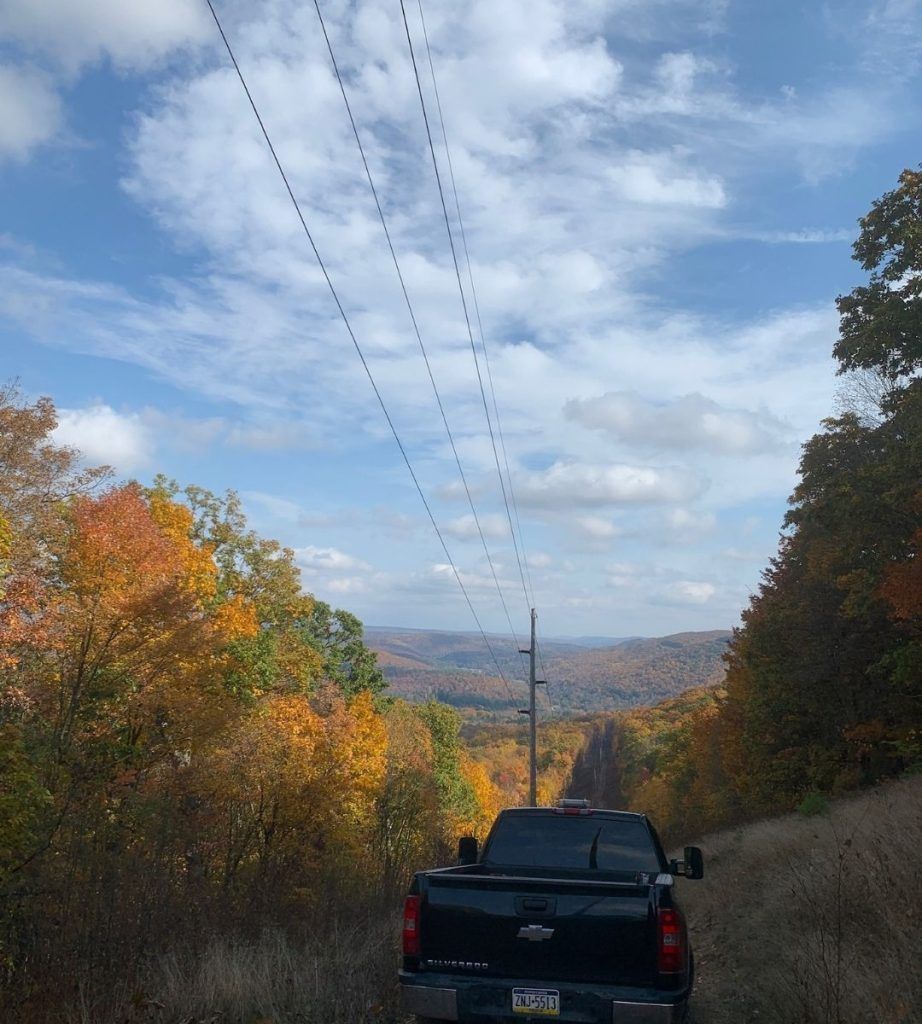 A chevrolet truck is driving down a dirt road