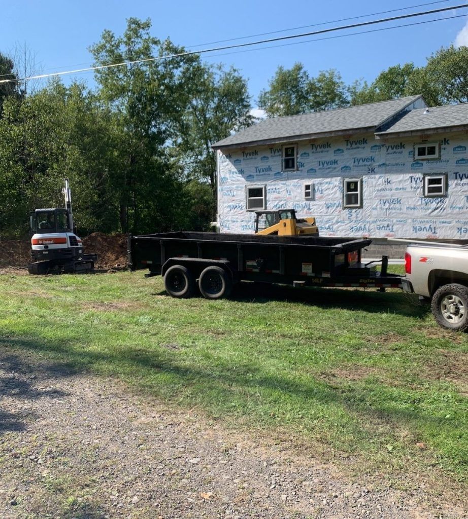 A dump truck is parked in front of a house.