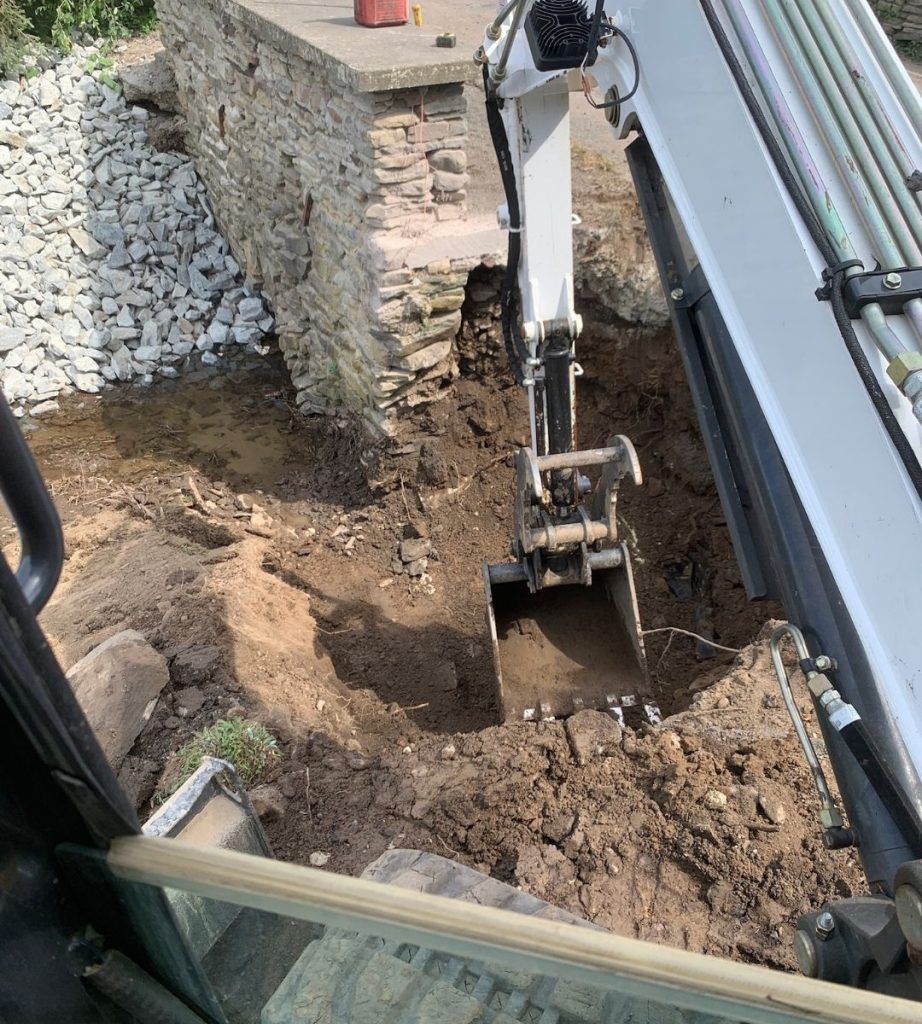 An excavator is digging a hole in the ground.