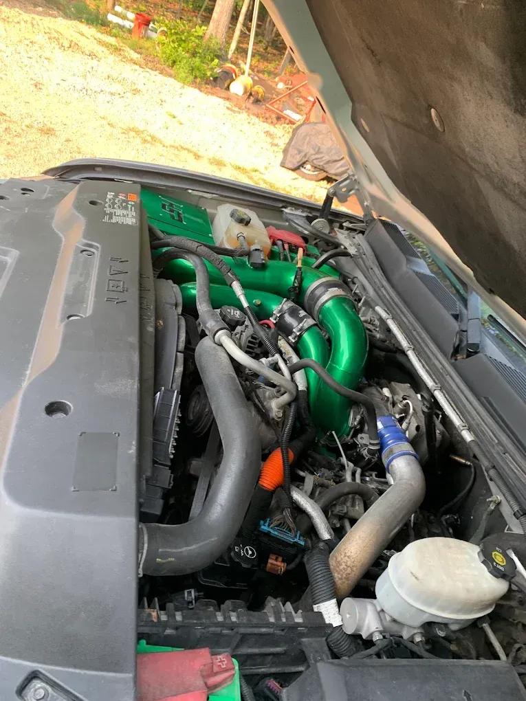 Green Exhaust Installed in Engine Block | Farmtuned Performance Diesel & Auto