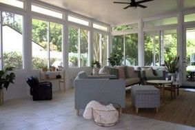 A spacious, sunlit living room featuring large floor-to-ceiling windows. A spacious, sunlit living room featuring large floor-to-ceiling windows.