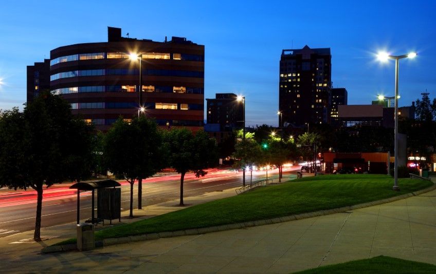 A woman is holding a tablet and talking to another woman.