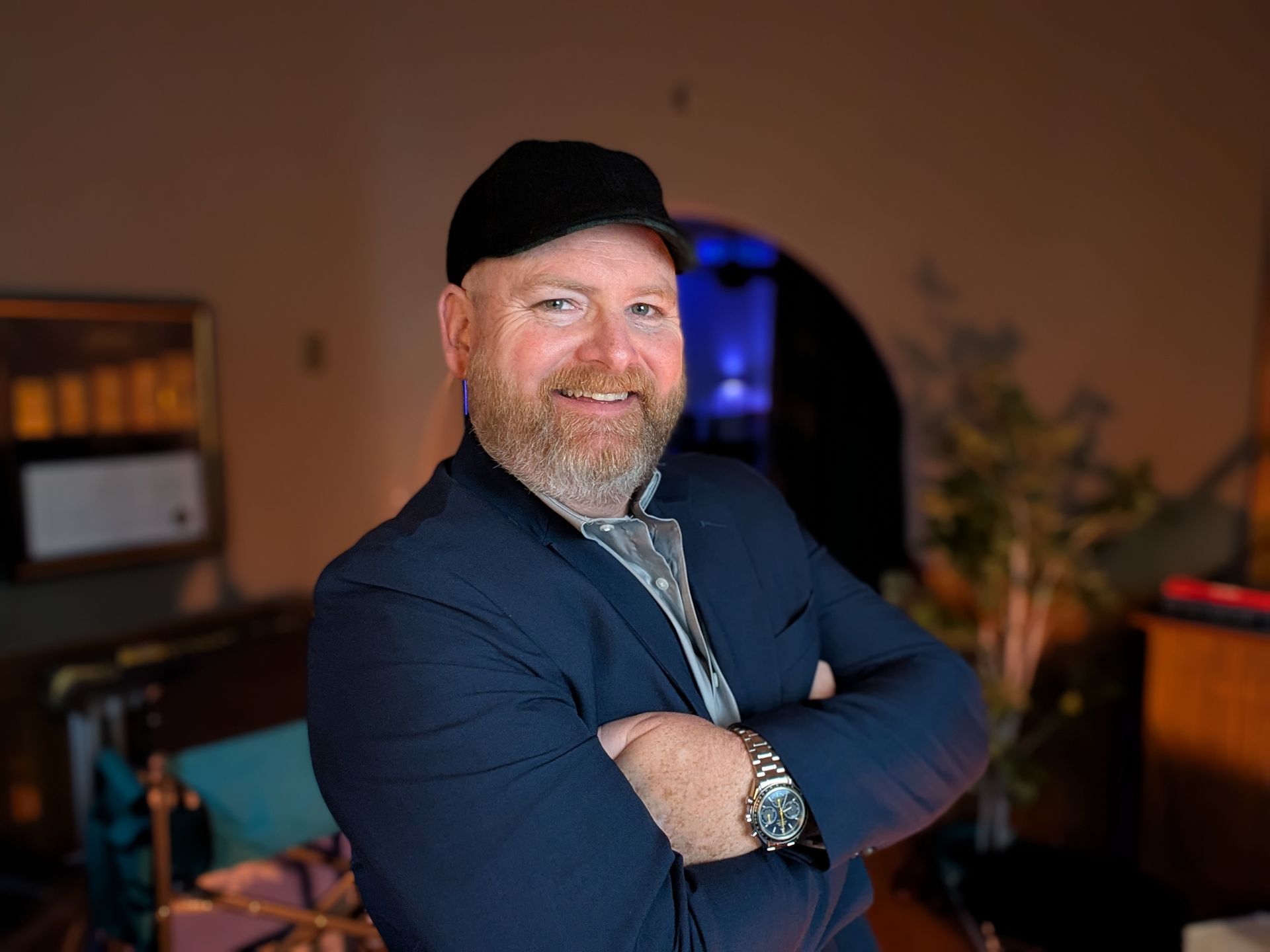 A group of people are sitting around a table with laptops.