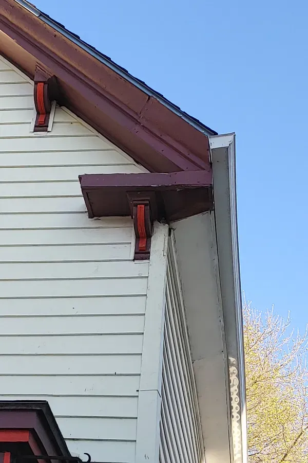 A close up of the side of a house with a blue sky in the background.