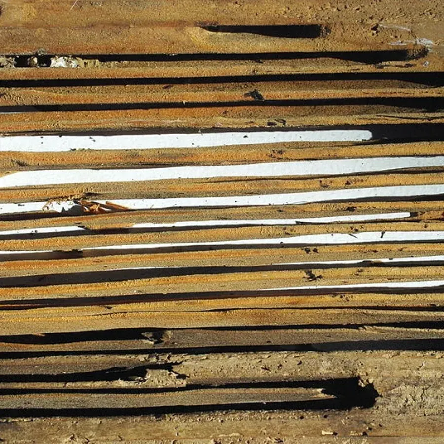 A close up of a stack of wooden boards
