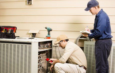 Men Repairing Air Conditioner — Ashley, OH — James Heating, Cooling, & Electrical