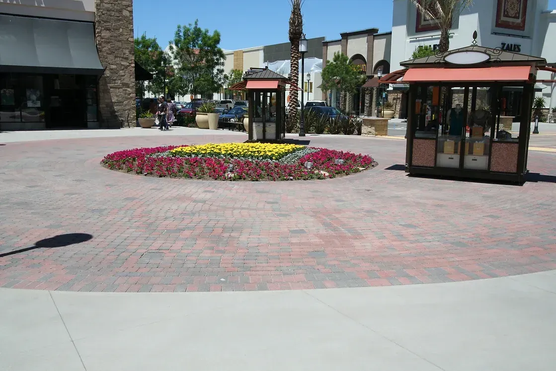 Claddagh Paving Corporation - a brick walkway with a circle of flowers in the middle
