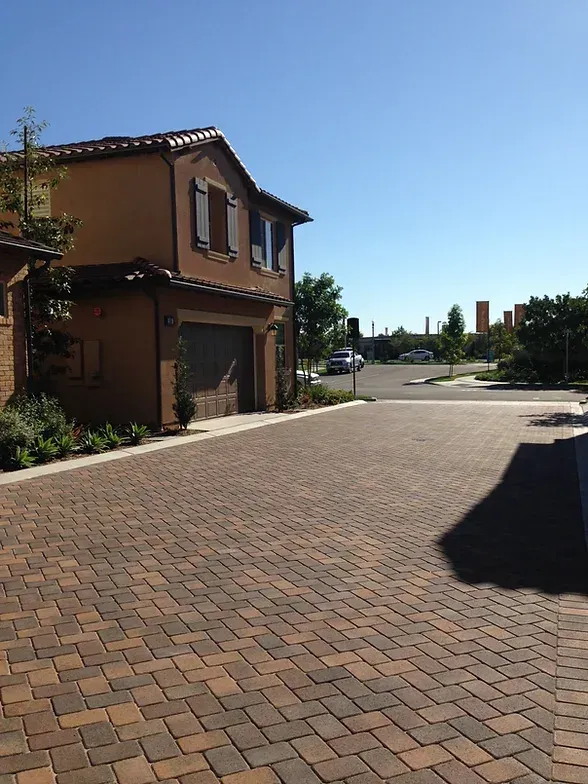 Claddagh Paving Corporation - a brick driveway leading to a house with a garage
