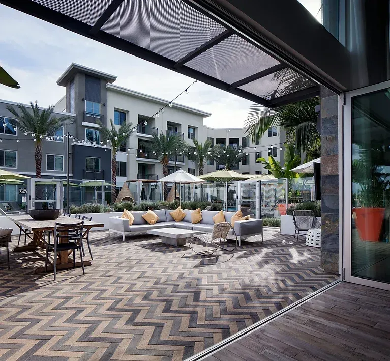 Claddagh Paving Corporation - a patio area with a herringbone pattern on the floor