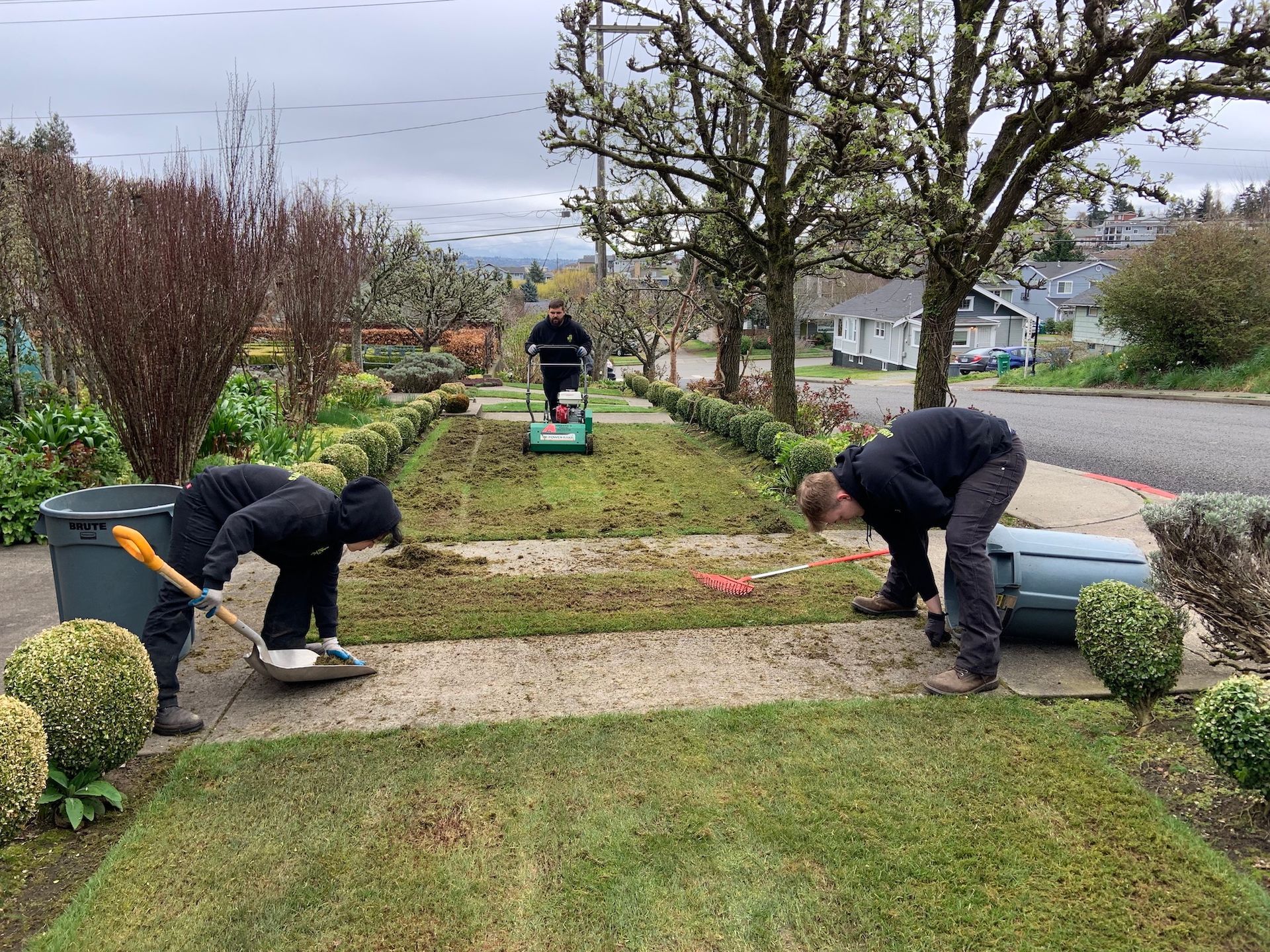 A group of people are working on a lawn.