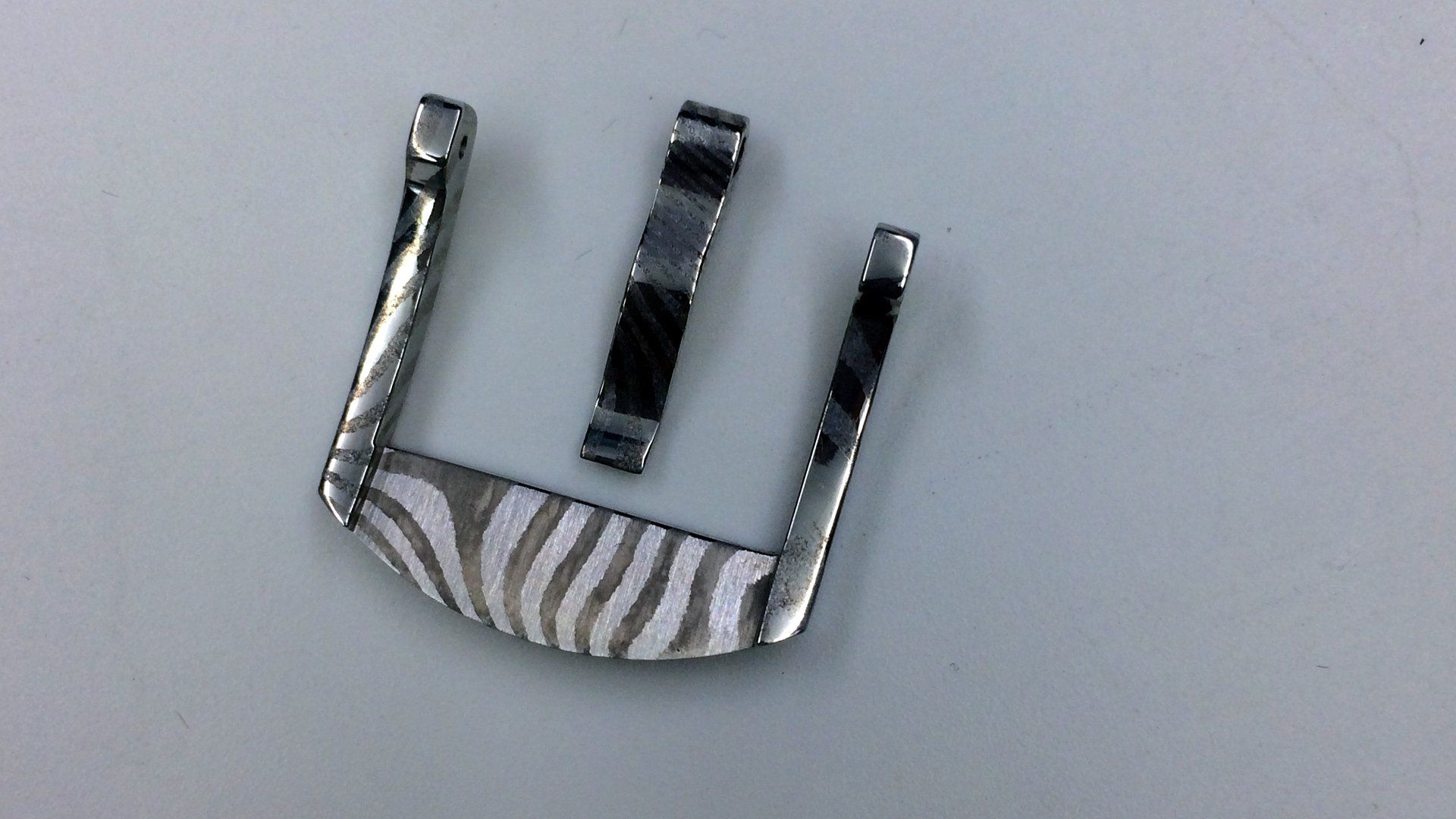 A silver buckle with a zebra print on it