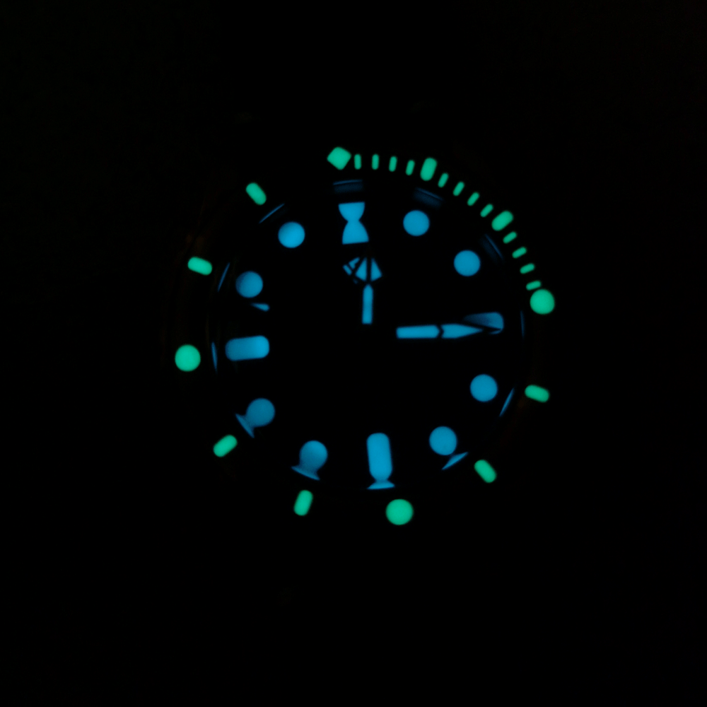 The face of a watch is glowing in the dark