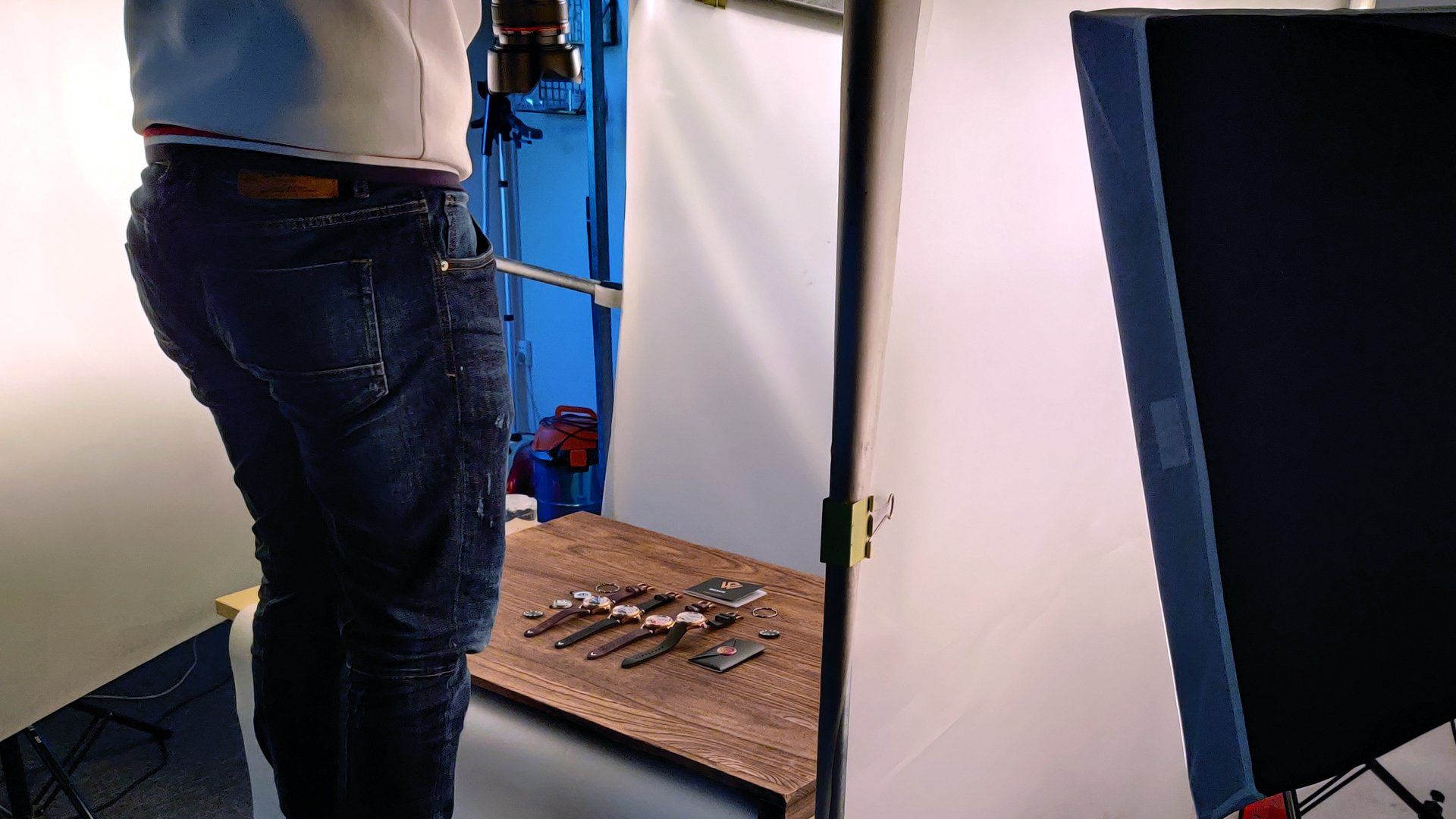 A man is standing in front of a table with tools on it