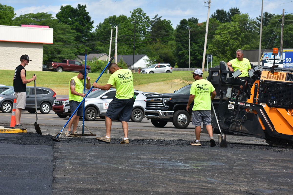 A group of men are working on a parking lot.