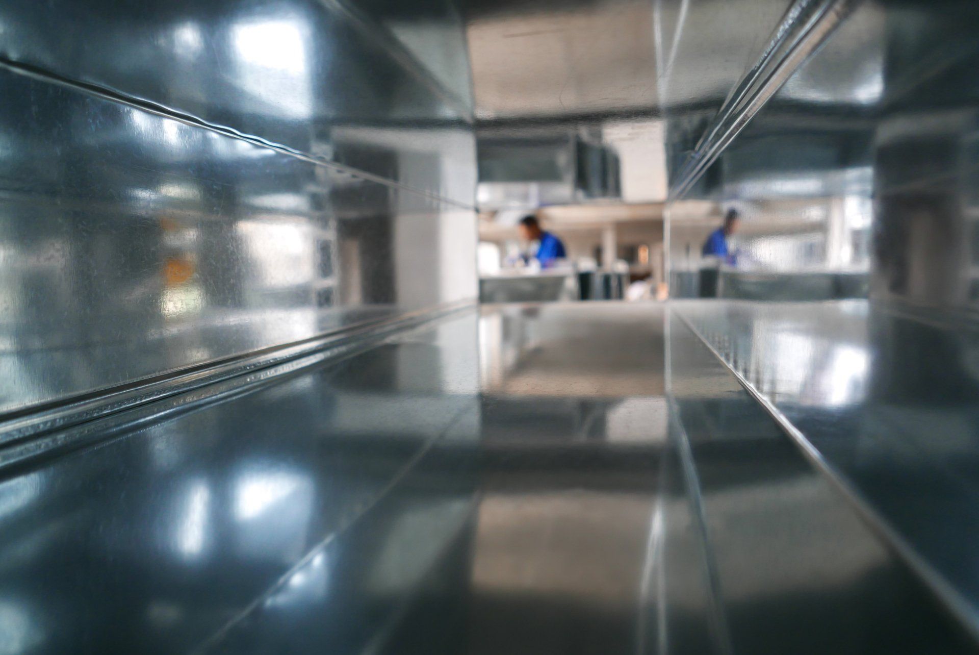 A reflection of a person in a mirror in a hallway