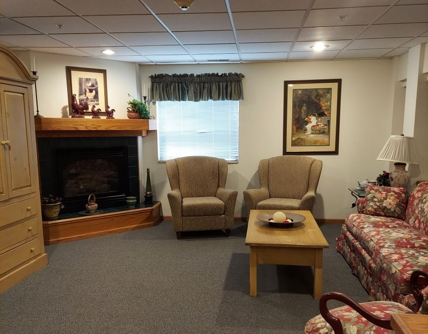 A room with a chair and a clock on the wall