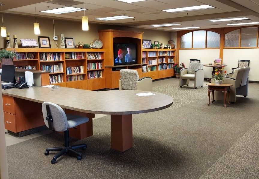 A library with a large table and chairs