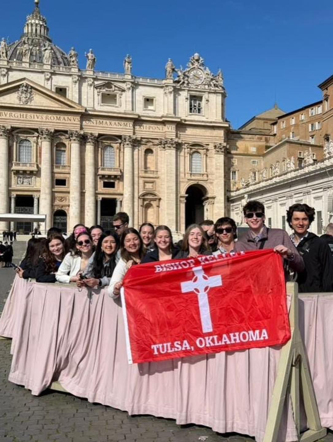 A group of students hold a red 