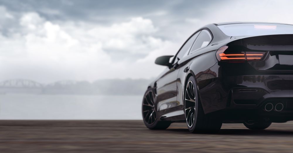 A Black Sports Car Is Parked on A Wooden Road — Sell Any Car Fast in North Lakes, QLD