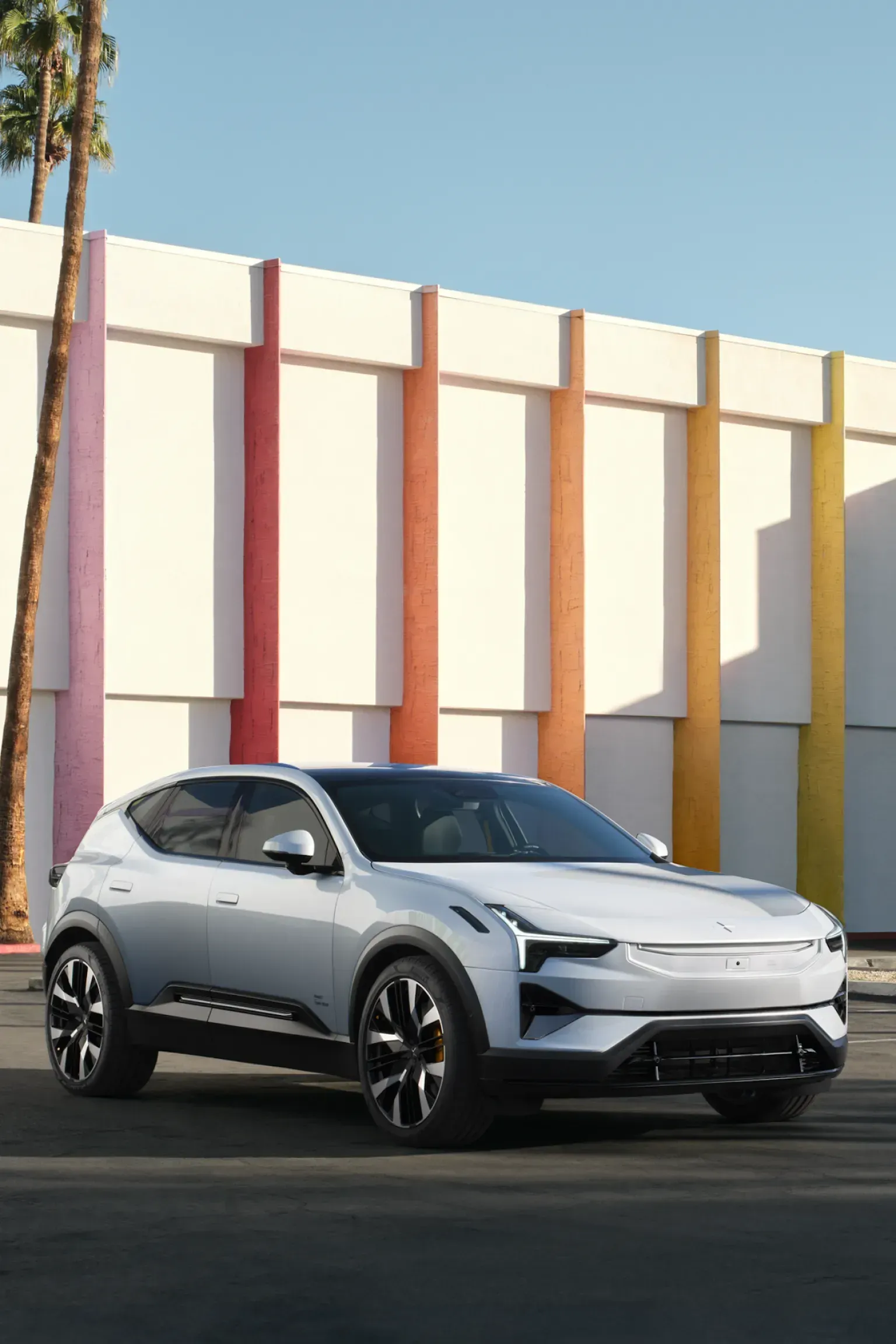 A White Car Is Parked in Front of A Colorful Building — Sell Any Car Fast in Eagle Farm, QLD