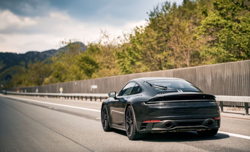A Black Car Is Driving Down a Highway — Sell Any Car Fast in Gold Coast, QLD