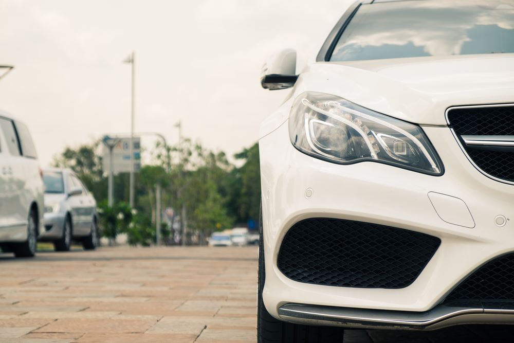A White Car Is Parked on The Side of The Road — Sell Any Car Fast in Gold Coast, QLD
