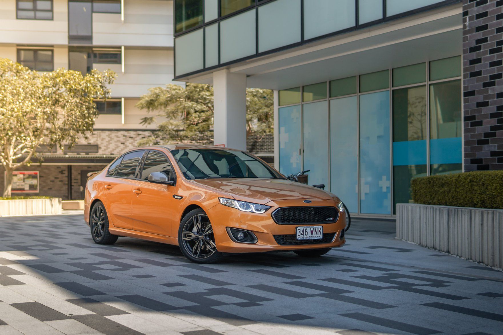 A Ford Falcon XR6 parked near a hotel