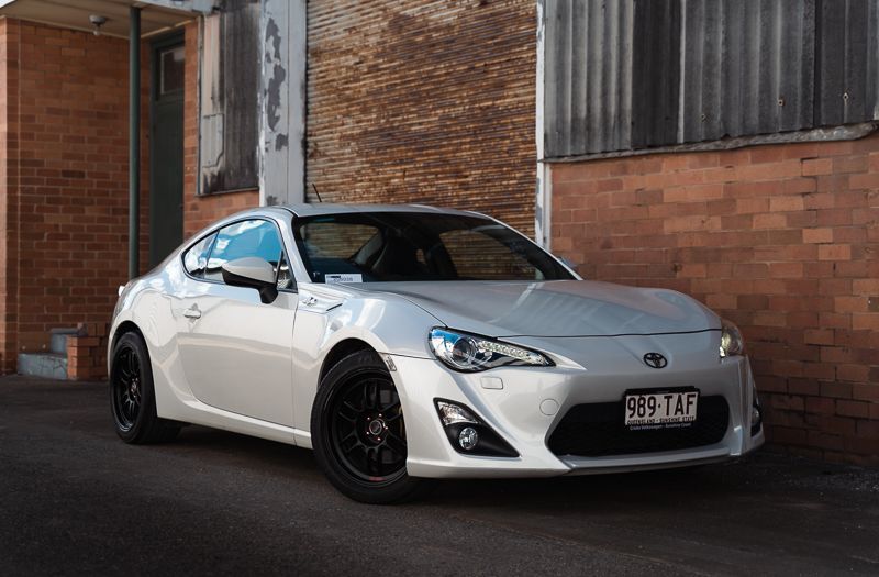 A white Toyota 86 with block wheels