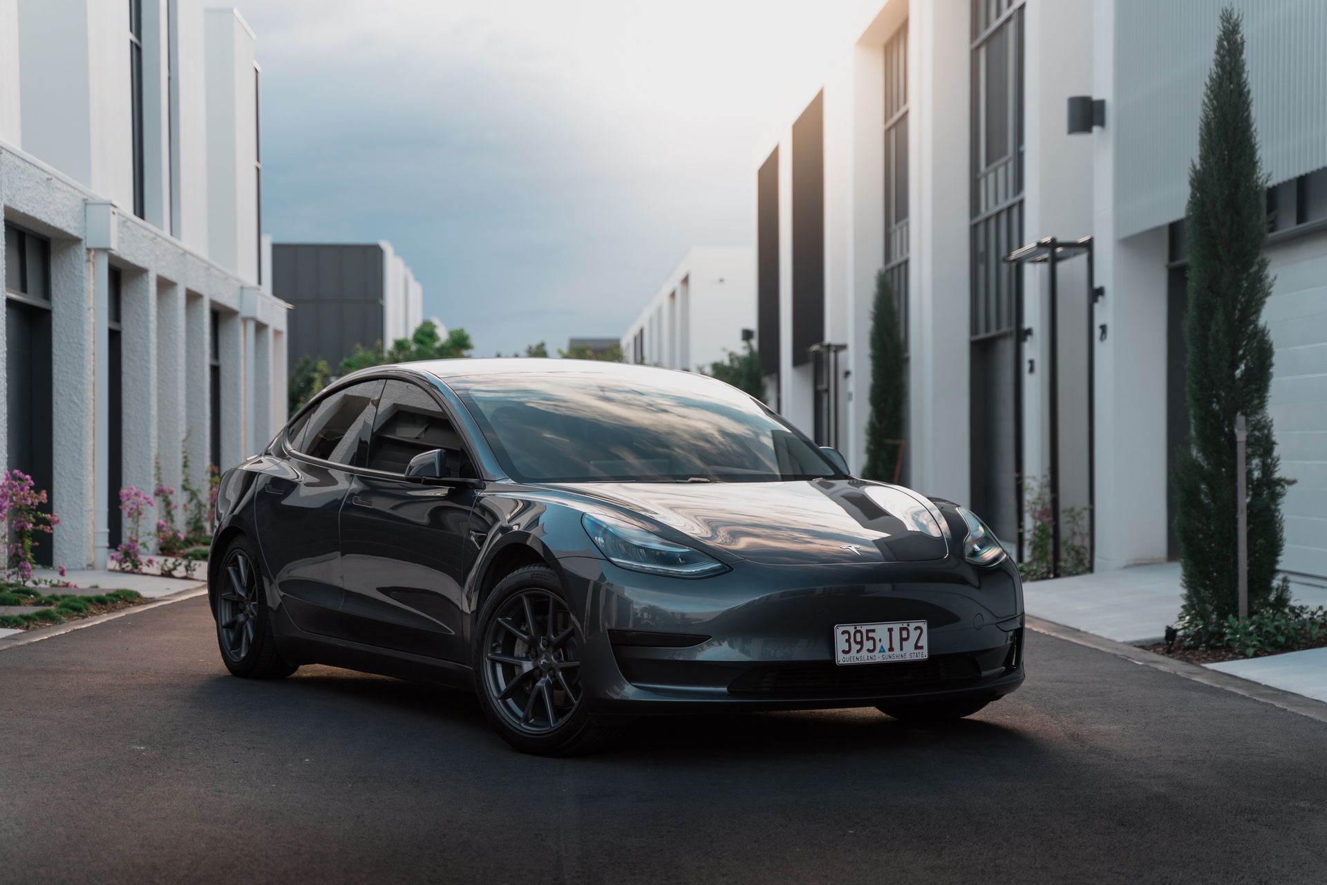 A grey Tesla Model 3 parked on a road -  sold to Sell Any Car Fast In Eagle Farm, QLD