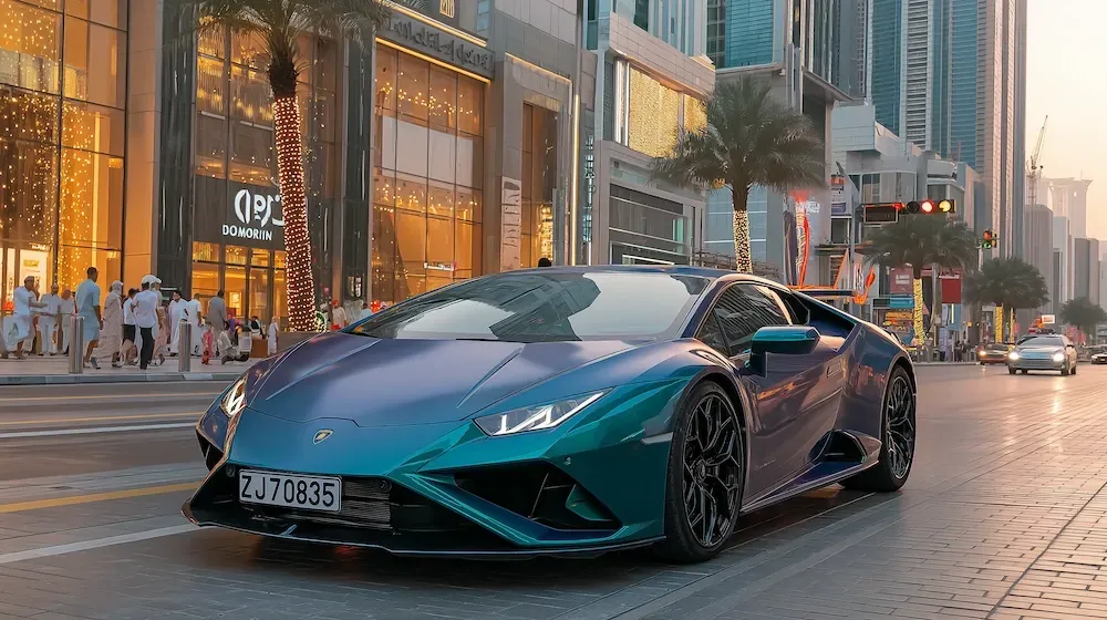A blue 2024 Lamborghini rental car driving in Dubai