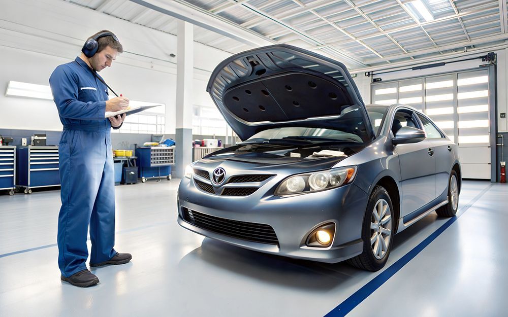 A mechanic inspects a car for a QLD RWC safety certificate - Sell Any Car Fast