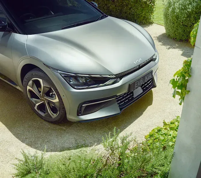 A Silver Car Is Parked in A Driveway Next to A Bush — Sell Any Car Fast in Eagle Farm, QLD