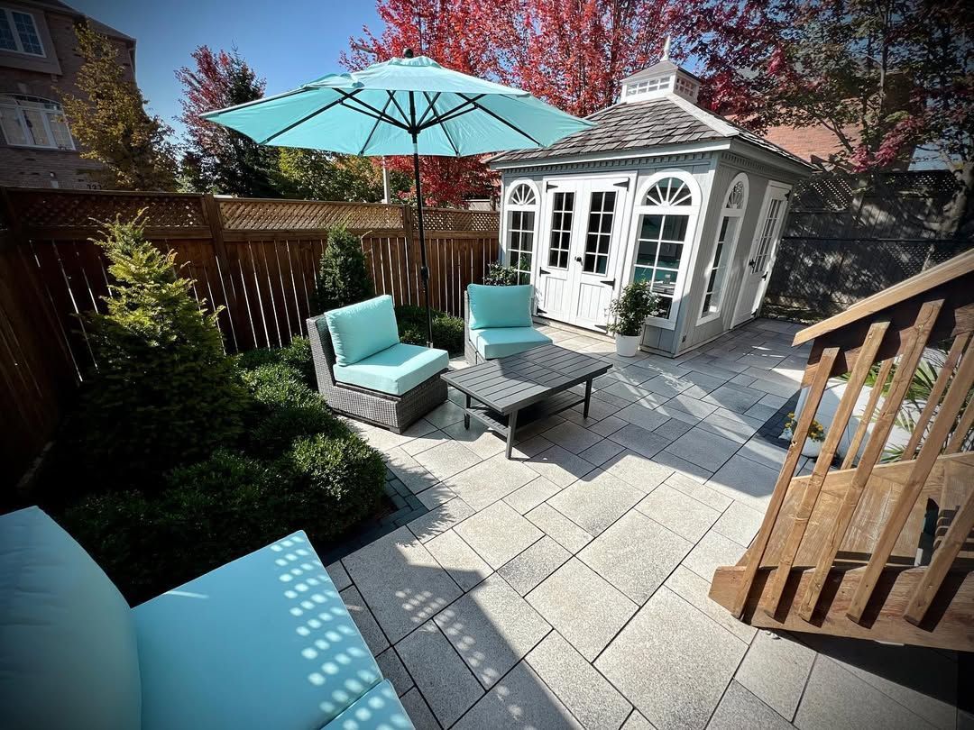 Man in black shirt holding coffee mug, smiling in a kitchen.