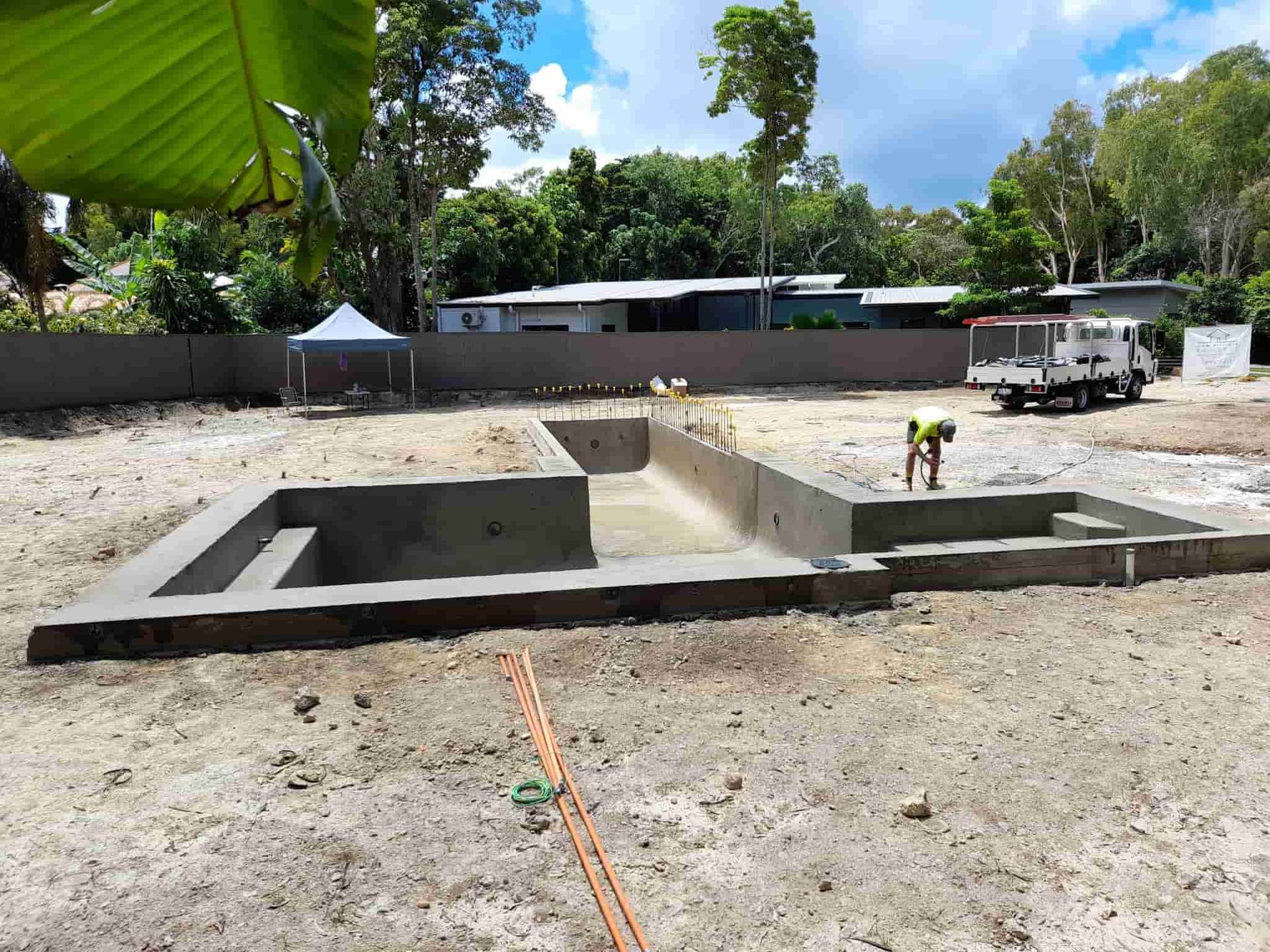 A Concrete Pool Is Being Built in A Dirt Field — Pools Plus NQ in Cairns, QLD